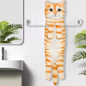 Detail showing an orange tabby cat-shaped hand towel hanging in a modern bathroom