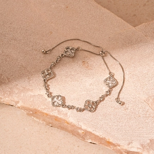 Elegant silver four-leaf clover bracelet with white mother-of-pearl and crystal accents
