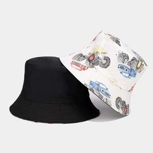 Detailed view of reversible sun hat showing colorful monster truck prints and neat stitching