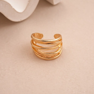 Macro detail of multilayer geometric open ring in glossy gold finish with smooth curves