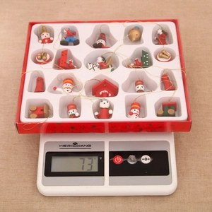 Detailed view of festive wooden Christmas ornaments in gift box on a digital scale
