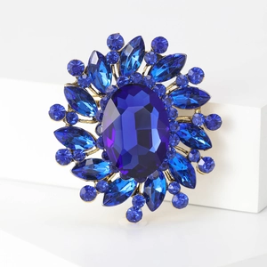 Vintage round brooch with deep blue faceted crystals and antique gold finish