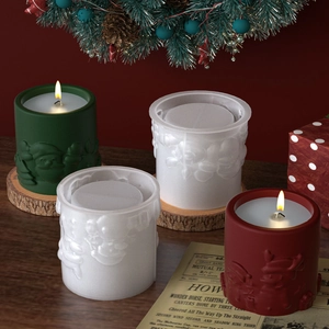 Embossed Santa and Reindeer silicone candle molds with finished Christmas themed candle samples