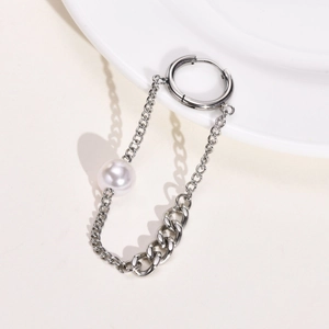 Detail of stainless steel hoop earrings featuring chains and a central white pearl