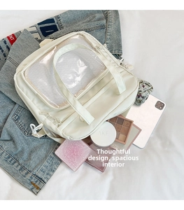 Close-up showing a large capacity white tote bag with clear PVC window and mesh pocket