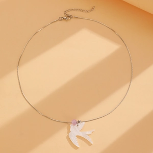 Détail du collier oiseau avec pendentif hirondelle blanche et perle rose sur chaîne argentée