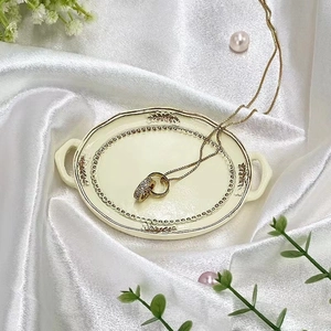 Detail of double interlocking rings necklace with diamonds on elegant white silk