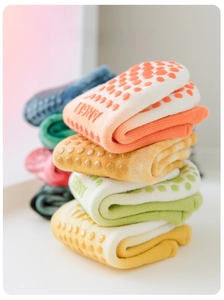 Close-up of multicolor non-slip yoga socks with silicone grippers and heart patterns