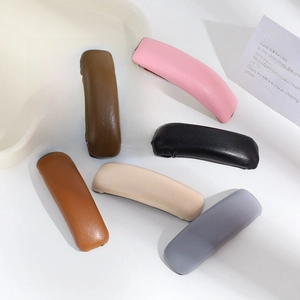 Set of minimalist PU leather pleated hair clips in six assorted neutral colors on a tray