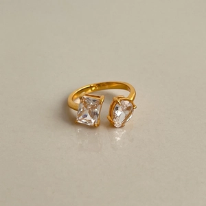 Macro detail of 18k gold plated open ring with square and teardrop zircon stones