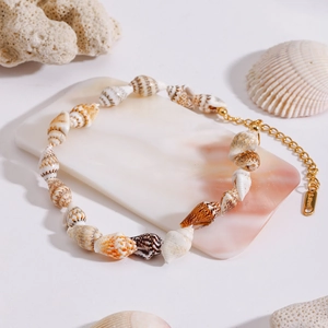 Detailed macro view of sea shell anklet with durable golden stainless steel lobster clasp