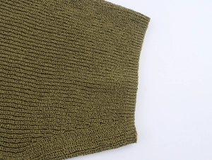 Macro detail of grass green knit fabric with textured horizontal wave pattern