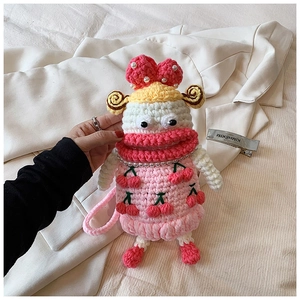 Detail of handmade crochet phone bag with pink cherry pattern and pearl accents