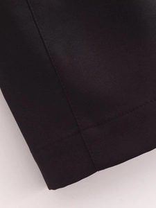 Close-up of black fabric texture with neat single-needle stitching on cuff or hem