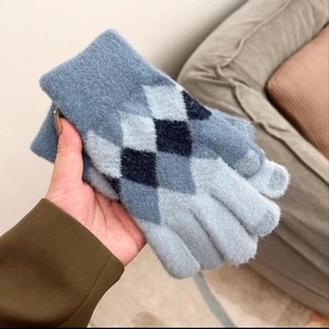 Close-up of diamond pattern knit gloves with touchscreen-compatible gray fingertips