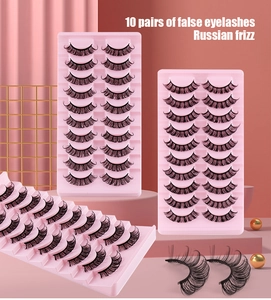 Detail of 10 pairs of black Russian curl false eyelashes on a pink tray background