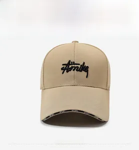 Close-up of beige cotton baseball cap with Amike embroidery and Sport print on the brim