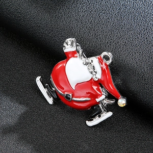 Close-up of skating Santa brooch with red enamel and crystal on black leather