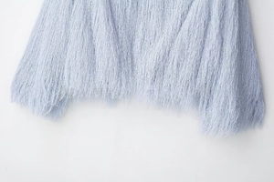 Detailed close-up of light blue fringe texture on a stylish casual jacket for women