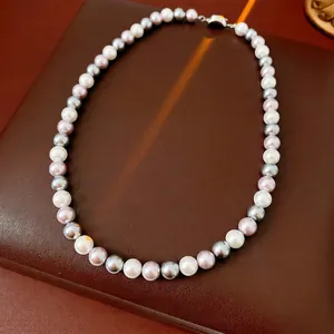 Elegant multi-color pearl necklace with white lavender and grey pearls on brown leather