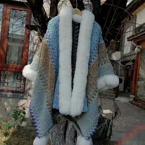 Ethnic knit shawl with white faux fur collar and tassels in blue and brown hues