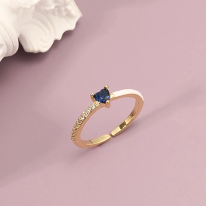 Adjustable gold ring featuring a deep blue heart gemstone and white enamel detail