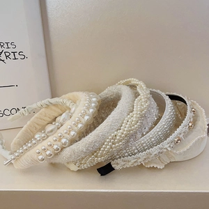 Detail of French vintage pearl and tweed headbands in creamy white and ivory tones