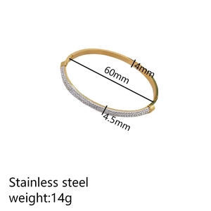 Gold stainless steel irregular bangle with crystals, featuring 60mm diameter and 14g weight