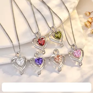 Macro shot of 925 silver heart necklaces with colorful gemstones in six different shades