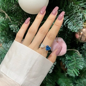 Close-up of elegant S925 silver ring featuring blue and white heart zircon stones on hand