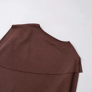 Deep brown knitted poncho featuring metallic thread and unique asymmetric double layer neckline