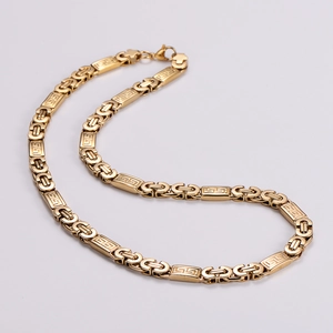 Detail of gold hip hop chunky chain with embossed rectangular links and lobster clasp