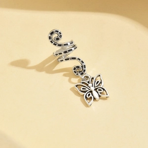 Macro view of silver alloy hair braid ring featuring a hollow butterfly charm pendant