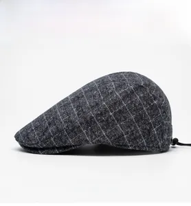 Detail of gray plaid flat cap featuring adjustable elastic drawstring for custom fit