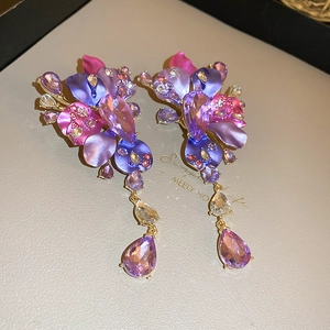 Detail of purple floral drop earrings with gradient petals and teardrop crystal pendants