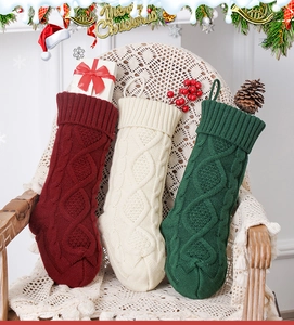 Detailed knit texture of festive Christmas stockings in red, white, and dark green