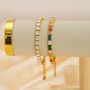 Elegant gold-plated chain bracelet with rectangular zircon crystals on a silk display