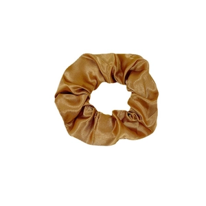 Golden brown satin silk scrunchie with elegant pleated texture and soft glossy finish