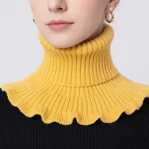 Detail of yellow knitted turtleneck dickey collar with vertical ribbed texture and wavy edges