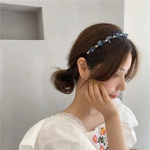 Detail of luxury baroque headband with navy blue crystals and white rhinestones