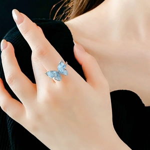 Elegant silver butterfly open ring with light blue zircon stones on a model hand