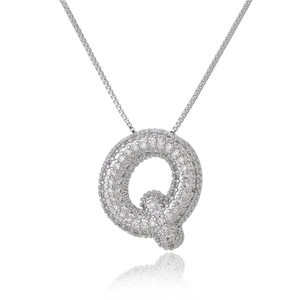 Macro detail of silver letter Q pendant with pavé cubic zirconia on a box chain