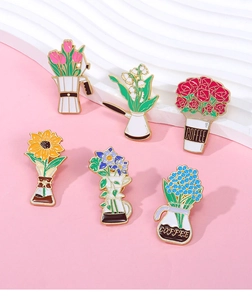 Macro detail of six floral enamel pins featuring colorful flowers in coffee pots and cups