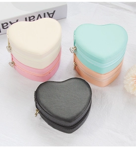 Multiple heart-shaped PU leather jewelry boxes in pastel colors on a textured background