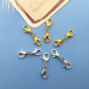 Flat lay of gold and silver double-ended lobster clasps for DIY jewelry making