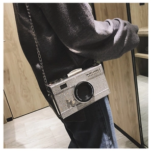 Detail of silver glitter camera bag with metal chain strap and Steal the Spotlight text