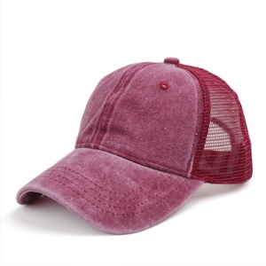 Detail of burgundy washed mesh trucker hat showing vintage texture and breathable net