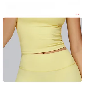 Close-up of high-elasticity yellow yoga vest featuring extended hem and tummy control design