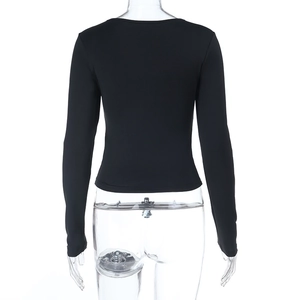 Back view of slim fit black long sleeve top with minimalist cutout detailing on fabric
