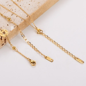 Detail of 18KGP gold plated finish on copper coin necklace with lobster clasp and chain